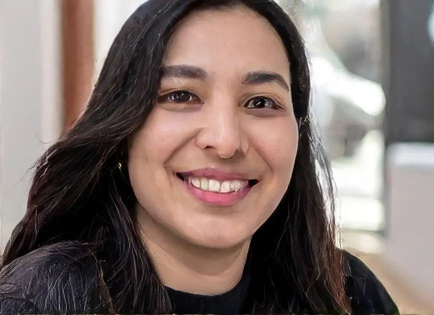 Black leather jacket with gold buttons and zipper.