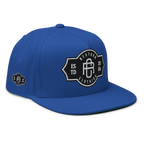 Royal blue RC Monogram flat bill snapback cap with shield logo