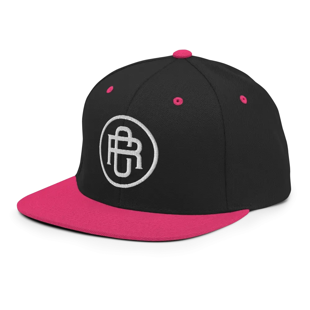 Black and pink RC Circle logo snapback cap with flat bill