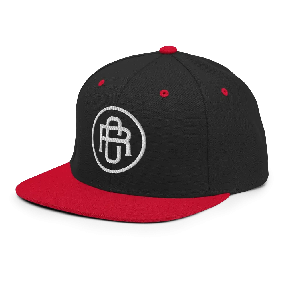 Black and red flat bill snapback cap with white RC circle logo