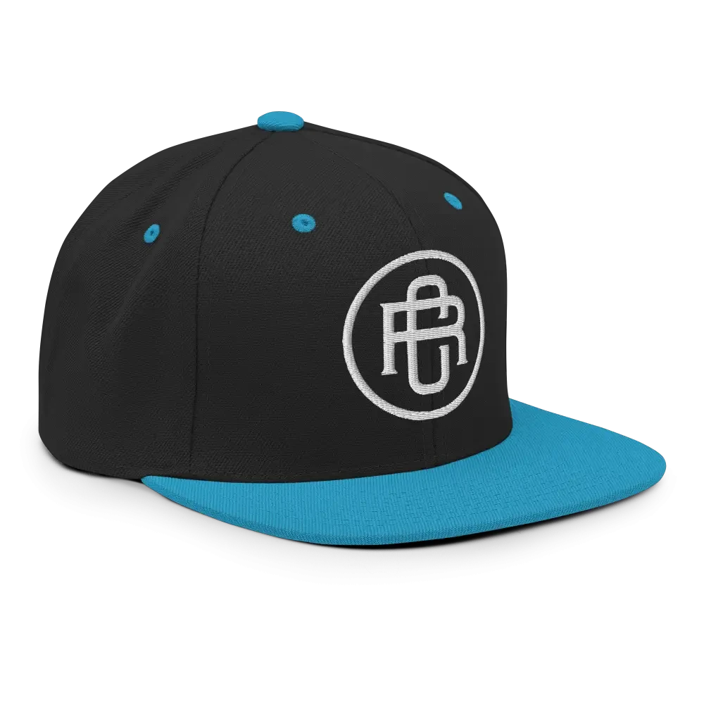 Black and teal flat bill snapback cap with white RC circle logo