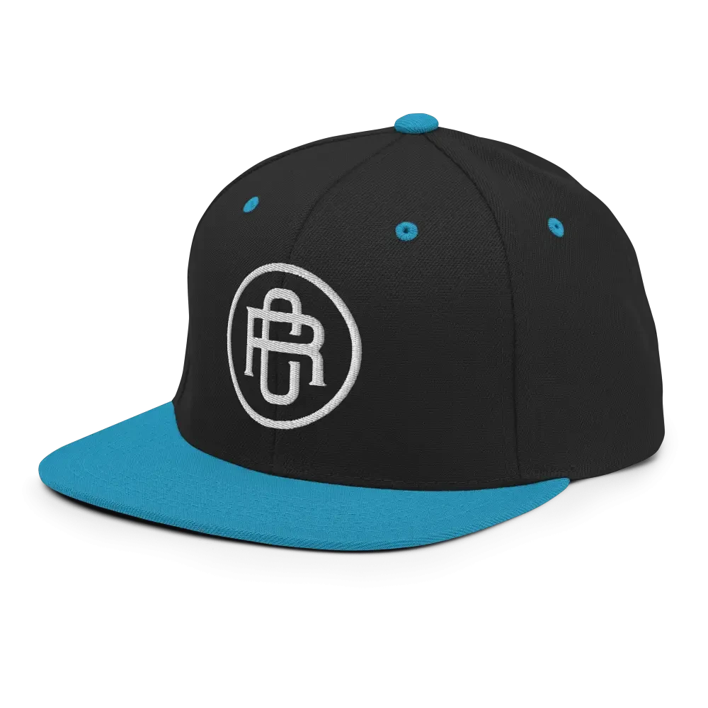 Black and teal flat bill snapback cap with white RC circle logo