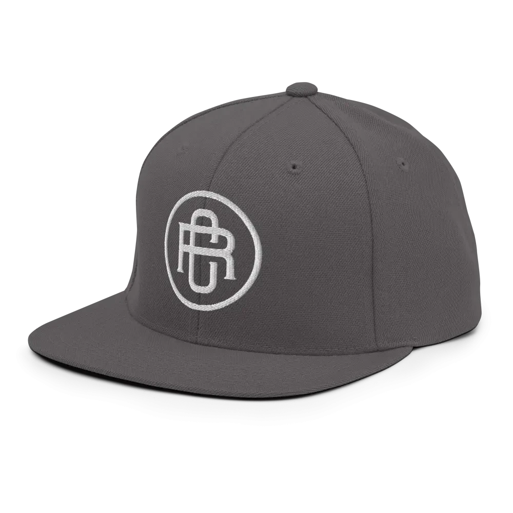 Charcoal gray flat bill snapback cap with white RC circle logo