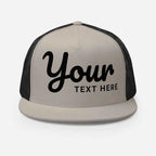 Black and beige mesh trucker cap with custom cursive text design